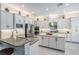 Bright, spacious kitchen features stainless steel appliances, white cabinets, and a large center island at 2468 Coco Palm Cir, Wesley Chapel, FL 33543
