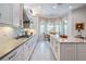 Bright, spacious kitchen features stainless steel appliances, white cabinets, and view to breakfast nook at 2468 Coco Palm Cir, Wesley Chapel, FL 33543