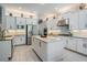 Open kitchen design with white cabinetry, stainless steel appliances, and center island at 2468 Coco Palm Cir, Wesley Chapel, FL 33543