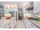 Kitchen with white cabinets, stainless appliances, center island, and view to dining area at 2468 Coco Palm Cir, Wesley Chapel, FL 33543