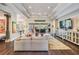 Spacious living room features coffered ceilings, modern decor, and seamless indoor-outdoor living at 2468 Coco Palm Cir, Wesley Chapel, FL 33543