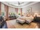 Well-lit main bedroom featuring a tray ceiling, large windows, and neutral color palette at 2468 Coco Palm Cir, Wesley Chapel, FL 33543