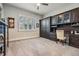 Home office with custom cabinets, desk, and large window providing plenty of natural light at 2468 Coco Palm Cir, Wesley Chapel, FL 33543