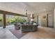 Outdoor living area with ample seating, covered patio, built-in grill, and serene pool views at 2468 Coco Palm Cir, Wesley Chapel, FL 33543