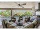 Inviting outdoor living area featuring a built-in grill, covered patio, comfortable seating and pool at 2468 Coco Palm Cir, Wesley Chapel, FL 33543
