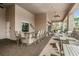 An outdoor area with a bar and tables provides ample seating for social gatherings and relaxation at 2468 Coco Palm Cir, Wesley Chapel, FL 33543