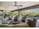 The expansive outdoor living space provides comfortable seating with views of the pool and landscaped backyard, creating a relaxing ambiance at 2468 Coco Palm Cir, Wesley Chapel, FL 33543