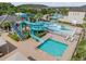 A lovely community water park with dual slides, a splash area, and a small pool for Gathering fun on a sunny day at 2468 Coco Palm Cir, Wesley Chapel, FL 33543