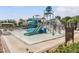 A community splash park with slides, a bucket, and other water features for children to enjoy on a sunny day at 2468 Coco Palm Cir, Wesley Chapel, FL 33543