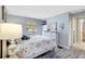 Bright bedroom features a large window, light blue walls, and wood-look flooring at 2700 Bayshore Blvd # 4204, Dunedin, FL 34698