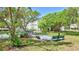 View of the Bocce Ball court surrounded by mature trees and benches at 2700 Bayshore Blvd # 4204, Dunedin, FL 34698