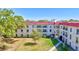 View of the building's exterior highlighting the lush central courtyard and access to units at 2700 Bayshore Blvd # 4204, Dunedin, FL 34698