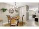 Inviting dining area with a round table, elegant chandelier, and unique wrought-iron chairs at 2700 Bayshore Blvd # 4204, Dunedin, FL 34698