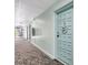 Hallway with carpet and the condo's front door has wreath on it at 2700 Bayshore Blvd # 4204, Dunedin, FL 34698