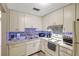 Clean kitchen featuring a dishwasher, stainless steel appliances, and ample lighting at 2700 Bayshore Blvd # 4204, Dunedin, FL 34698