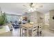 Open-concept condo with dining area flowing into a living room with large windows at 2700 Bayshore Blvd # 4204, Dunedin, FL 34698