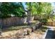 Beautiful backyard featuring a wood fence, mature trees, and tasteful wood landscaping in a well-maintained lawn at 275 S Highland Ave, Tarpon Springs, FL 34689