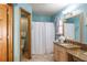 Bright bathroom features a light wood vanity with granite countertops and a decorative shower curtain at 275 S Highland Ave, Tarpon Springs, FL 34689