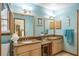 Bathroom with dual vanities, granite counters, and stylish decor at 275 S Highland Ave, Tarpon Springs, FL 34689