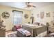 Cozy bedroom showcases a decorative ceiling fan, a neutral color palette, and comfortable furnishings at 275 S Highland Ave, Tarpon Springs, FL 34689