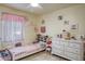 Bright, cheerful bedroom with a twin bed, white dresser, and personalized wall decor at 275 S Highland Ave, Tarpon Springs, FL 34689