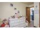 Bright ' bedroom featuring white dresser, framed photos, and a door to the rest of the home at 275 S Highland Ave, Tarpon Springs, FL 34689
