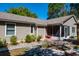 Charming single story home with neutral siding, a cozy screened patio, and well-manicured landscaping at 275 S Highland Ave, Tarpon Springs, FL 34689