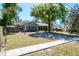 Exterior view of a well-maintained home with a two-car garage and a spacious front yard at 275 S Highland Ave, Tarpon Springs, FL 34689