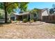 Single-story home with a two-car garage, shutters, and a well-manicured lawn and landscaping at 275 S Highland Ave, Tarpon Springs, FL 34689