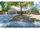 Charming single-story home with a well-maintained lawn, mature tree, and a two-car garage at 275 S Highland Ave, Tarpon Springs, FL 34689