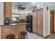 Kitchen with an island bar and light wood cabinetry offers ample storage space at 275 S Highland Ave, Tarpon Springs, FL 34689