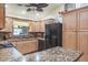 Kitchen featuring bar seating, granite countertops, and black appliances at 275 S Highland Ave, Tarpon Springs, FL 34689