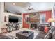 Cozy living room with stone fireplace, large television, and tile flooring at 275 S Highland Ave, Tarpon Springs, FL 34689