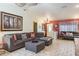 Open concept living room with a comfortable sectional, tile floors, and ample natural light at 275 S Highland Ave, Tarpon Springs, FL 34689