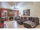 Comfortable living room features a stone fireplace, ceiling fan, and neutral toned decor at 275 S Highland Ave, Tarpon Springs, FL 34689
