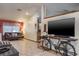 Open living room with tile floors and a modern entertainment center on bicycle at 275 S Highland Ave, Tarpon Springs, FL 34689