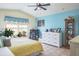Bedroom with yellow quilt, aqua walls, and natural light at 275 S Highland Ave, Tarpon Springs, FL 34689