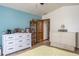 Spacious bedroom featuring tile floors, soft lighting, and ensuite bathroom at 275 S Highland Ave, Tarpon Springs, FL 34689