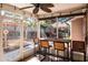 Relax in this screened patio with a tiki table, exterior bar, and hot tub in the backyard at 275 S Highland Ave, Tarpon Springs, FL 34689