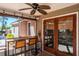 Enjoy the comfort of this cozy covered patio with bar seating and a ceiling fan at 275 S Highland Ave, Tarpon Springs, FL 34689