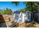 Storage shed with wooden access ramp, surrounded by a wooden fence and mature trees on a sunny day at 275 S Highland Ave, Tarpon Springs, FL 34689