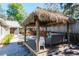 Tiki hut with outdoor seating, backyard access, perfect for entertaining and relaxation by the patio at 275 S Highland Ave, Tarpon Springs, FL 34689