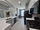 Modern kitchen featuring stainless steel appliances, white quartz countertops, and light gray cabinets at 29123 Crossland Dr, Wesley Chapel, FL 33543