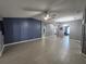 Spacious living room featuring tile floors, ceiling fan, and neutral paint colors at 29123 Crossland Dr, Wesley Chapel, FL 33543