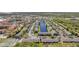 Aerial view of a neighborhood with a central pond, surrounded by lush trees and ample parking at 297 Countryside Key Blvd, Oldsmar, FL 34677