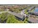 An aerial view of a neighborhood showcases lush greenery and ample parking in a tranquil setting at 297 Countryside Key Blvd, Oldsmar, FL 34677