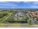 Aerial view of the residential community featuring a pool, serene lake, and well-maintained landscaping at 297 Countryside Key Blvd, Oldsmar, FL 34677