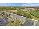 Aerial view features residences alongside a sports complex, lush trees, and a parking lot at 297 Countryside Key Blvd, Oldsmar, FL 34677