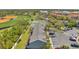 An aerial view of a community with tennis courts, a sports field and ample parking spaces at 297 Countryside Key Blvd, Oldsmar, FL 34677