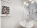 Clean bathroom with a white sink, arched mirror, and decorative towels at 297 Countryside Key Blvd, Oldsmar, FL 34677